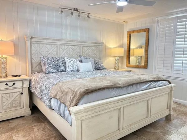 a spacious bedroom with a bed and a cabinets