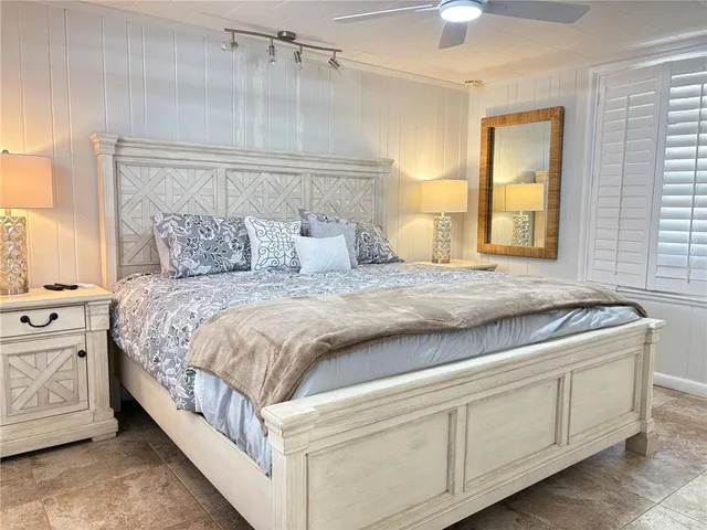 a spacious bedroom with a bed and a cabinets