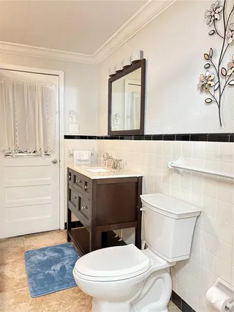 a bathroom with a toilet a sink and mirror