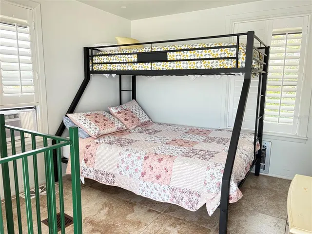 a bathroom with a granite countertop toilet sink and mirror