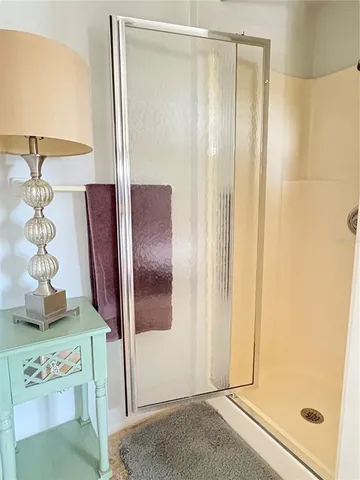 a bathroom with a glass shower door