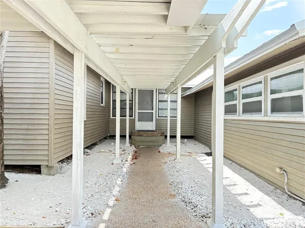 a view of a house with backyard porch and sitting area
