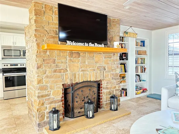 a living room with fireplace furniture and a flat screen tv