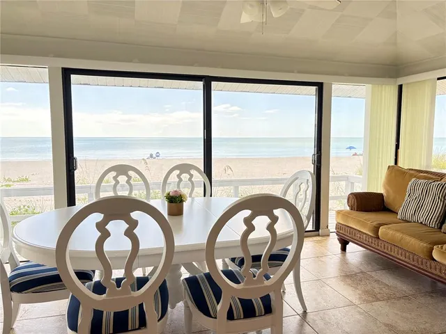 a living room with couches a table and chairs