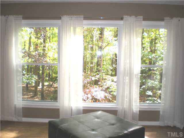 3417 Hackney Court Raleigh, NC 27613 - Photo 8 of 23 Large triple windows in living room offer this gorgeous view of the backyard, bringing nature indoors! Living Room