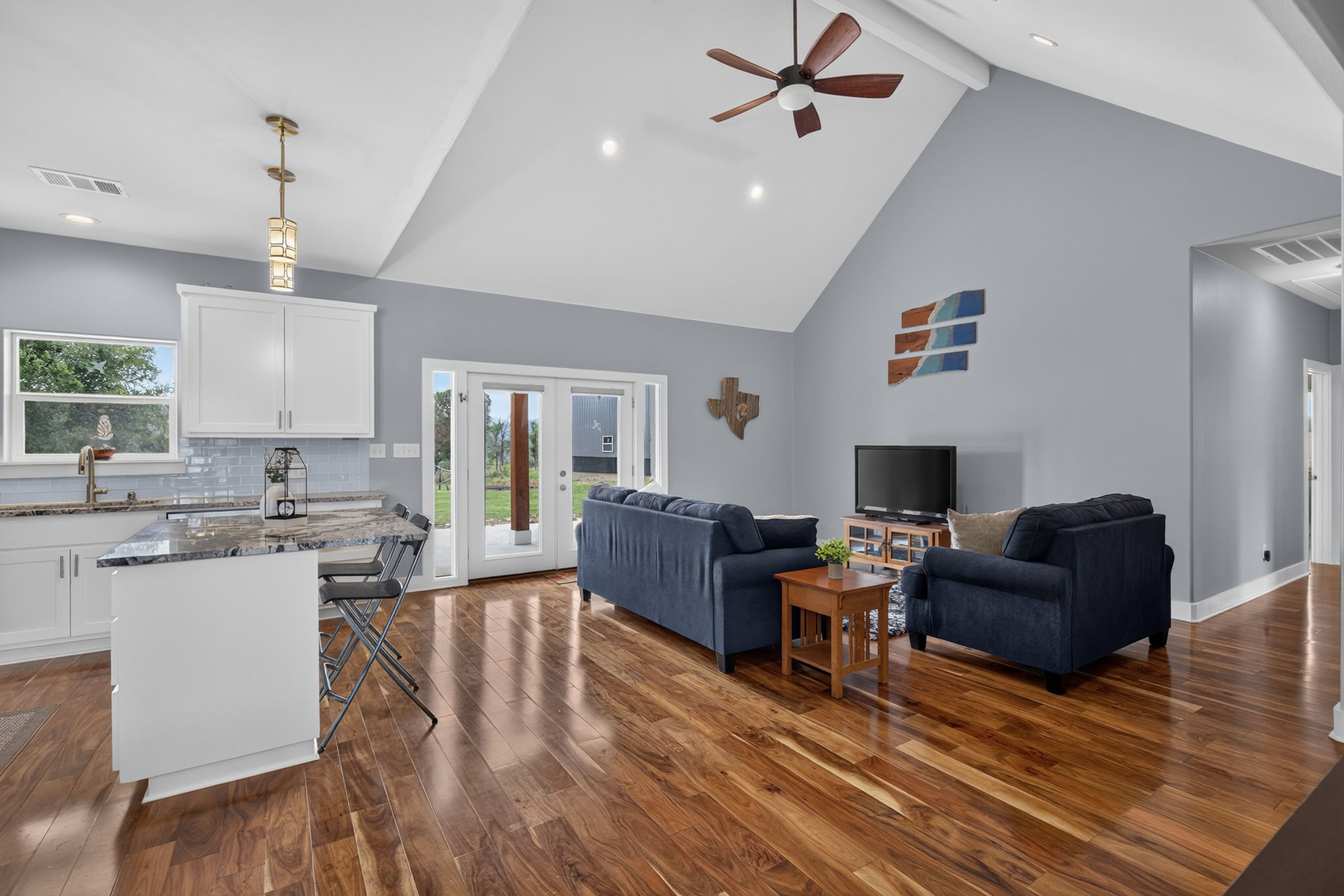 207 Deer Ridge Drive Burnet, TX 78611 - Photo 16 of 36 A striking open-concept living space features soaring vaulted ceilings and gleaming hardwood floors.