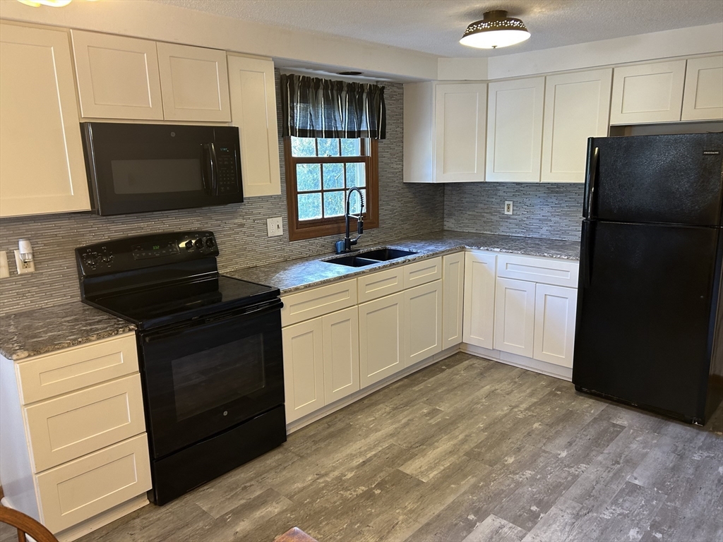 10 Pearl Street Ware, MA 01082 - Photo 2 of 12 a kitchen with a sink stove and refrigerator