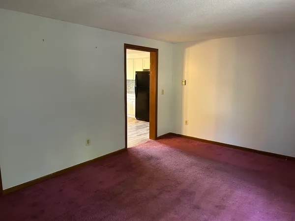 an empty room with closet and a window