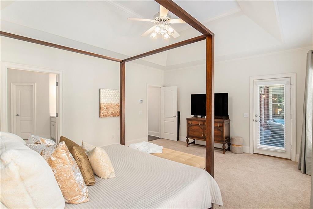 960 Providence Lane Monroe, GA 30656 - Photo 24 of 53 a bedroom with a bed and a flat tv screen on wall