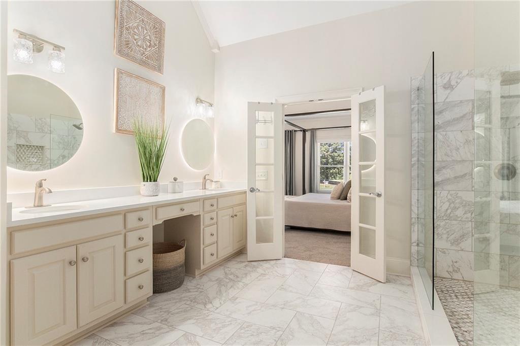 960 Providence Lane Monroe, GA 30656 - Photo 25 of 53 a en suite bathroom with a double vanity sink a mirror and a bathtub