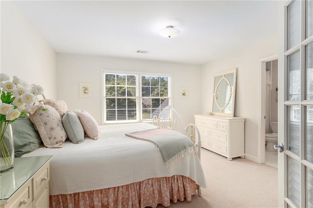 960 Providence Lane Monroe, GA 30656 - Photo 32 of 53 a bedroom with a bed and wooden floor