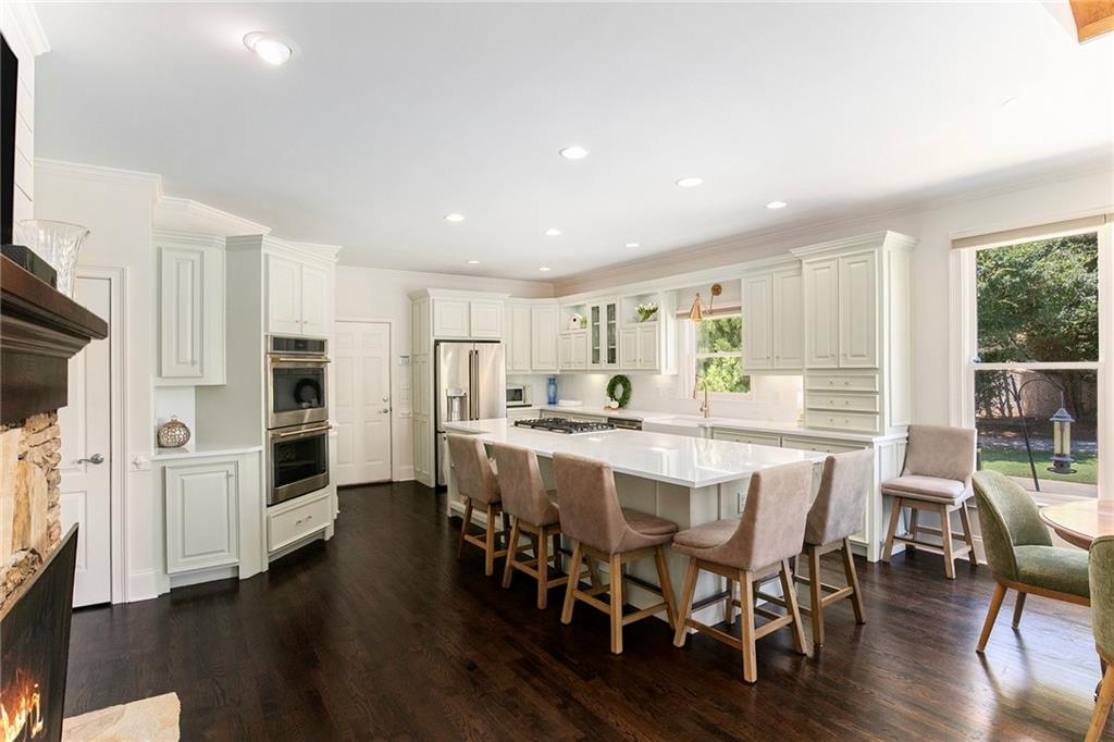 960 Providence Lane Monroe, GA 30656 - Photo 9 of 53 a large kitchen with a table and chairs