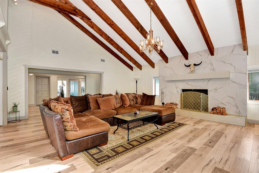 213 Riverbend Road Ormond Beach, FL 32174 - Photo 14 of 78 a living room with furniture and a fireplace