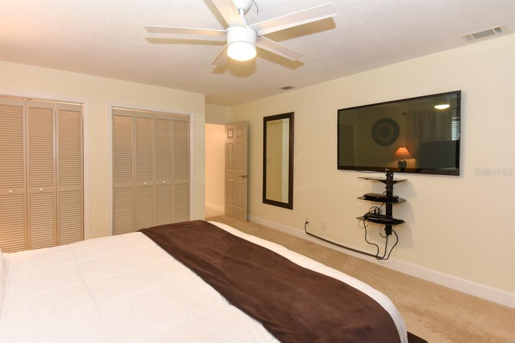 213 Riverbend Road Ormond Beach, FL 32174 - Photo 30 of 78 a bedroom with a bed and a hallway