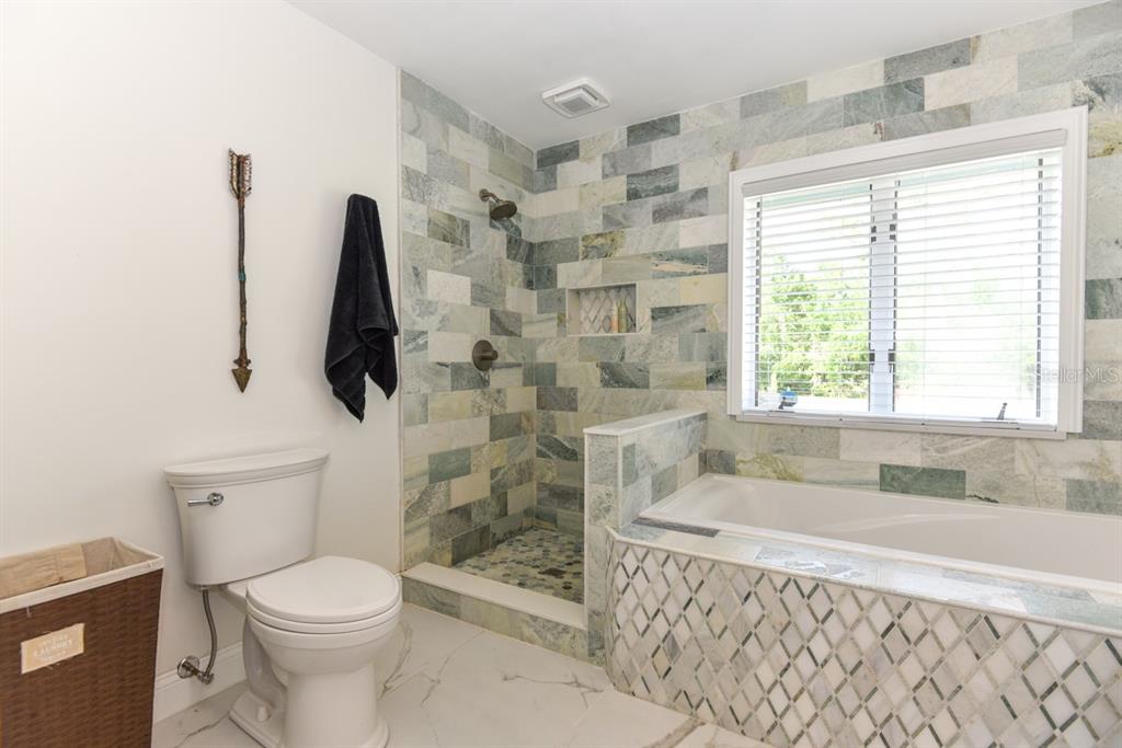 213 Riverbend Road Ormond Beach, FL 32174 - Photo 32 of 78 a bathroom with a toilet and a bathtub