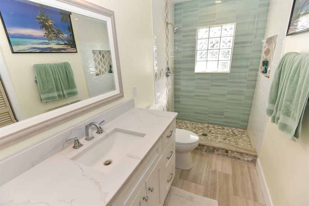 213 Riverbend Road Ormond Beach, FL 32174 - Photo 39 of 78 a bathroom with a sink a toilet and shower