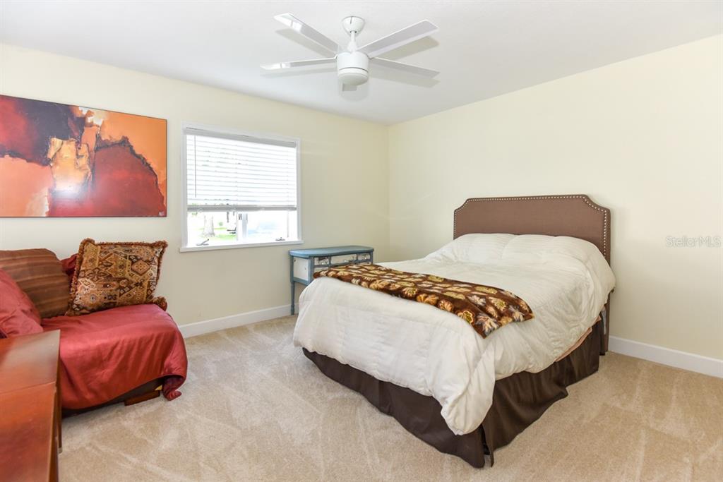 213 Riverbend Road Ormond Beach, FL 32174 - Photo 42 of 78 a bedroom with a bed and a couch
