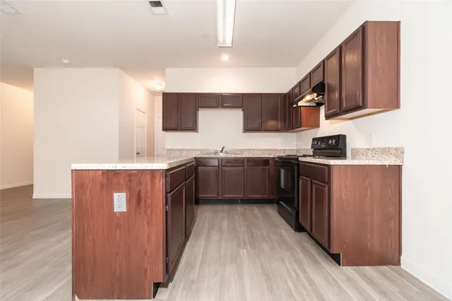 a kitchen with stainless steel appliances sink a microwave and cabinets