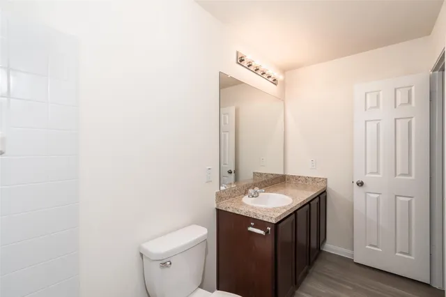 a bathroom with a sink toilet and mirror
