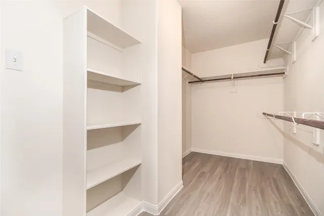 a view of walk in closet with empty racks