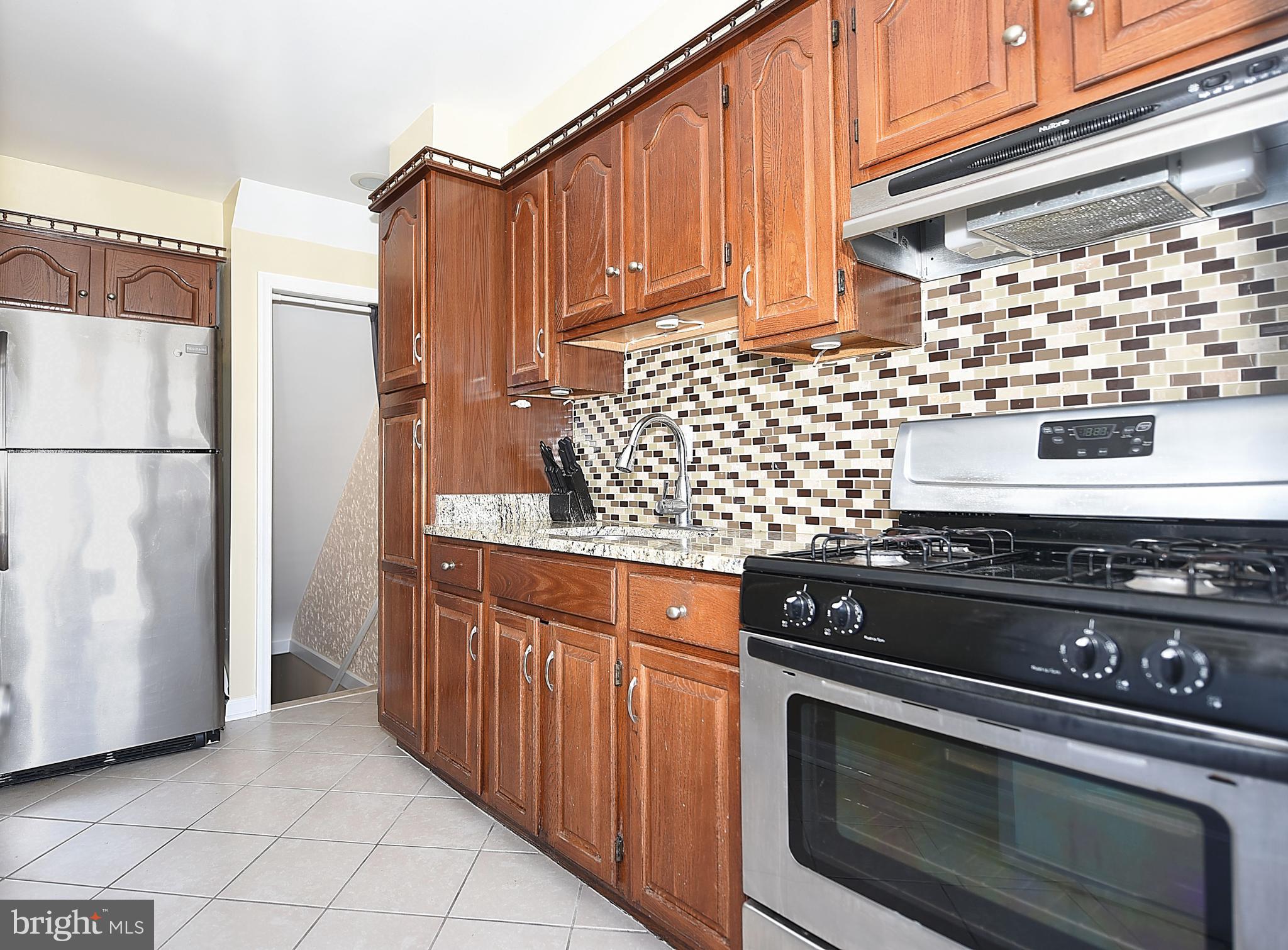 4423 Fenor Road Baltimore, MD 21227 - Photo 11 of 28 a kitchen with stainless steel appliances a stove and a refrigerator