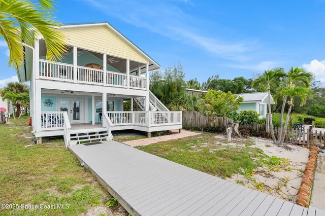 a view of house with yard and sitting area