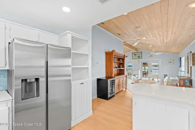 a kitchen with stainless steel appliances kitchen island granite countertop a refrigerator and a sink