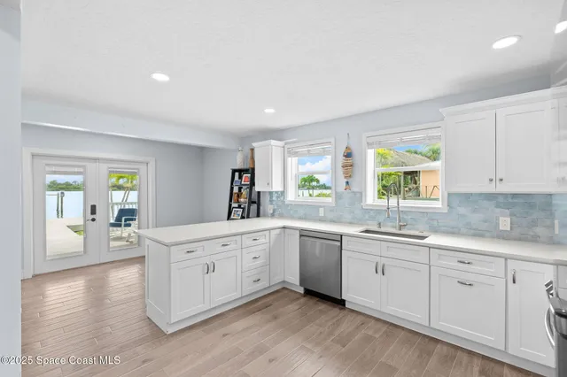 a large white kitchen with a window