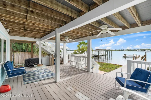 a view of a porch with wooden floor and stairs