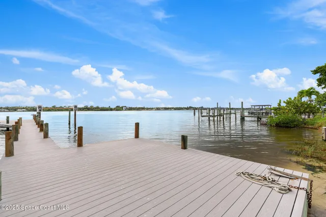 a view of a lake with a table and chairs
