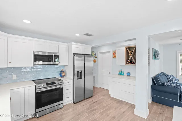 a kitchen with stainless steel appliances a refrigerator stove and microwave