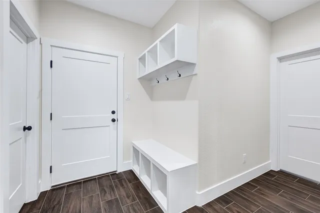 a view of an empty room with wooden floor