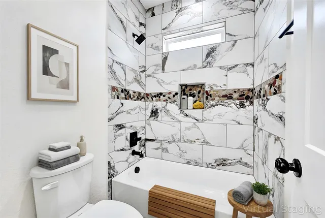 a bathroom with a toilet and a shower