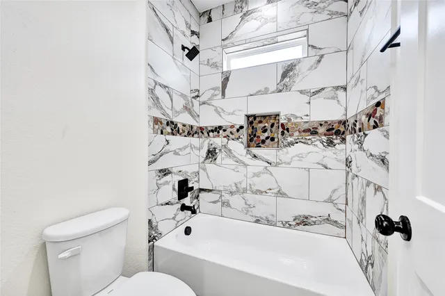 a bathroom with a bathtub and shower