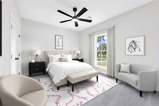 a spacious bedroom with a bed a couch and a window