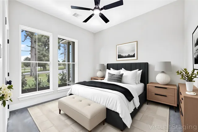 a spacious bedroom with a bed and glass window