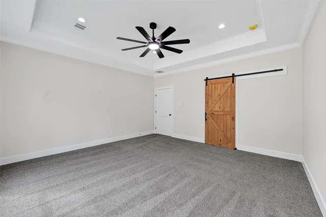 an empty room with closet and a ceiling fan