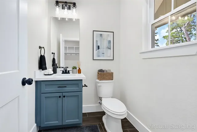 a bathroom with a toilet a sink and mirror