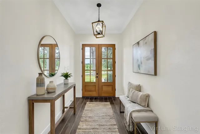 a living room with furniture a window and a chandelier