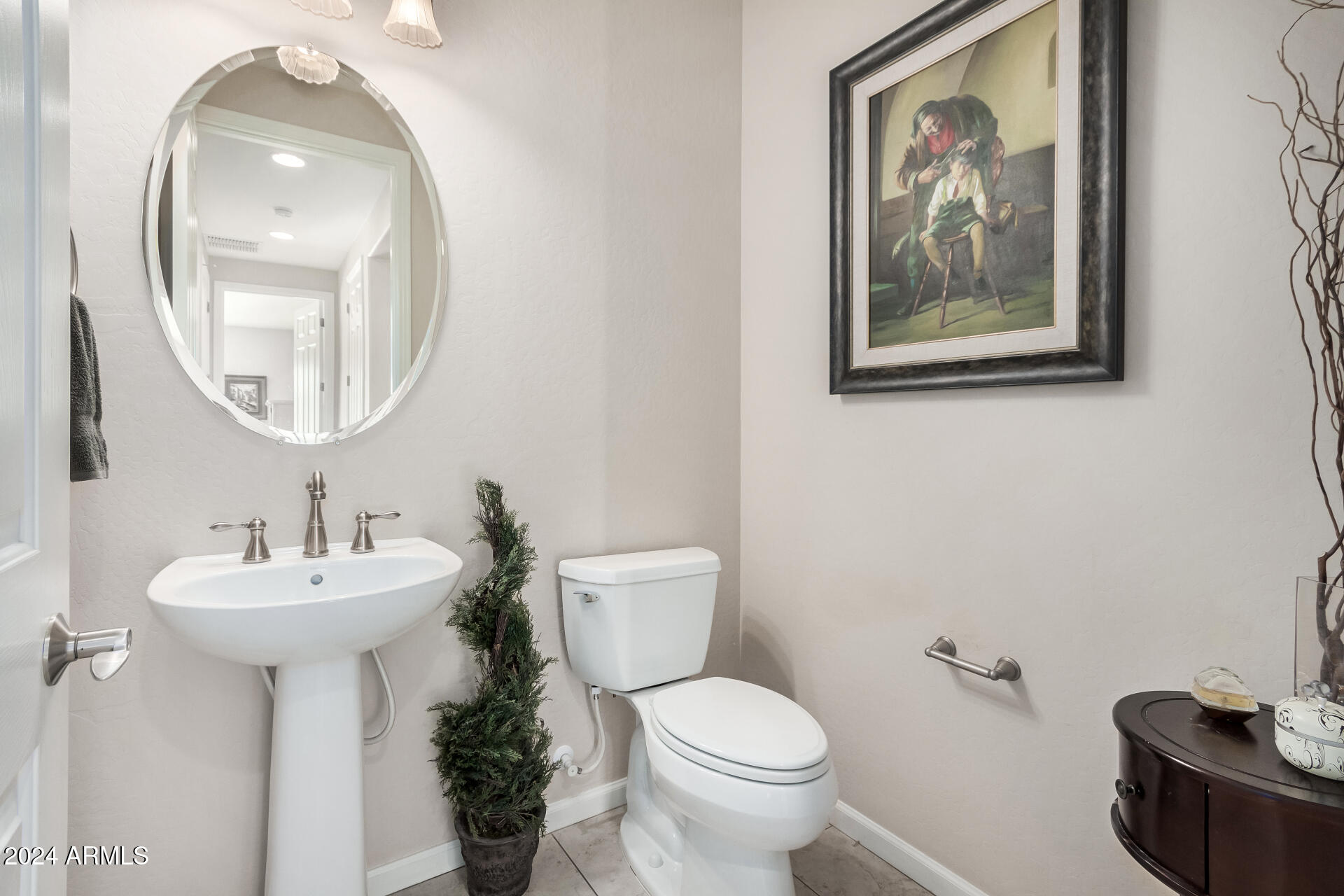 16538 West Berkeley Road Goodyear, AZ 85395 - Photo 10 of 31 a bathroom with a toilet a sink and a mirror