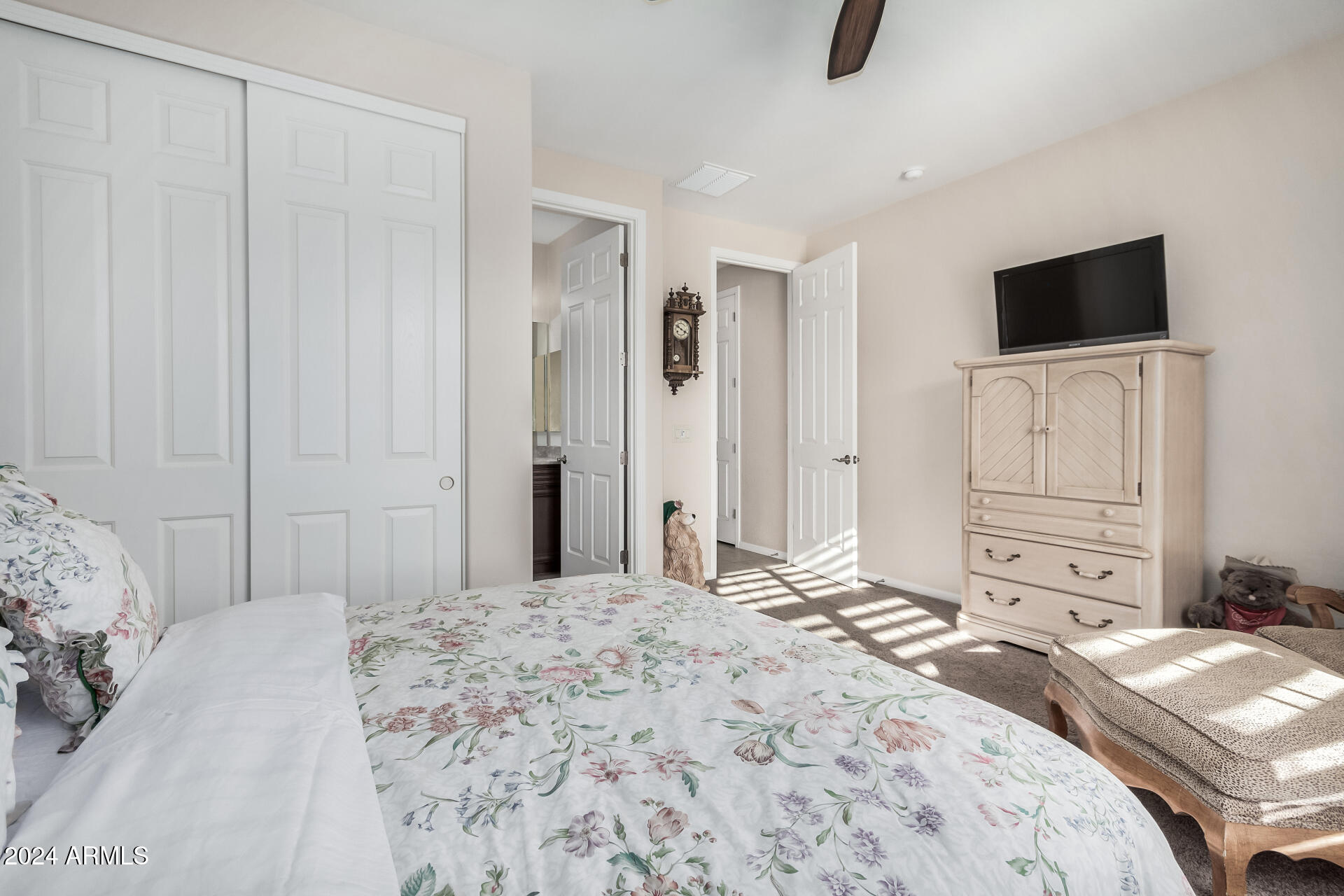 16538 West Berkeley Road Goodyear, AZ 85395 - Photo 16 of 31 a bedroom with a bed and a flat tv screen on dresser