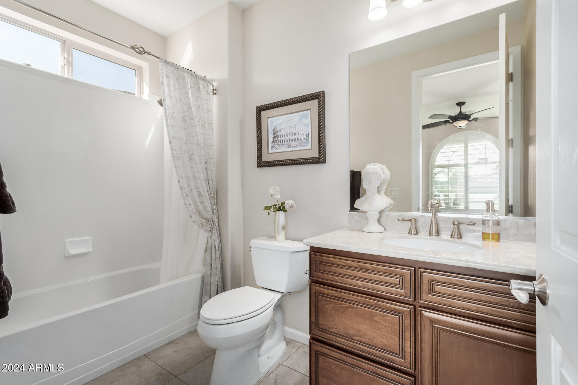16538 West Berkeley Road Goodyear, AZ 85395 - Photo 17 of 31 a bathroom with a sink a toilet and shower
