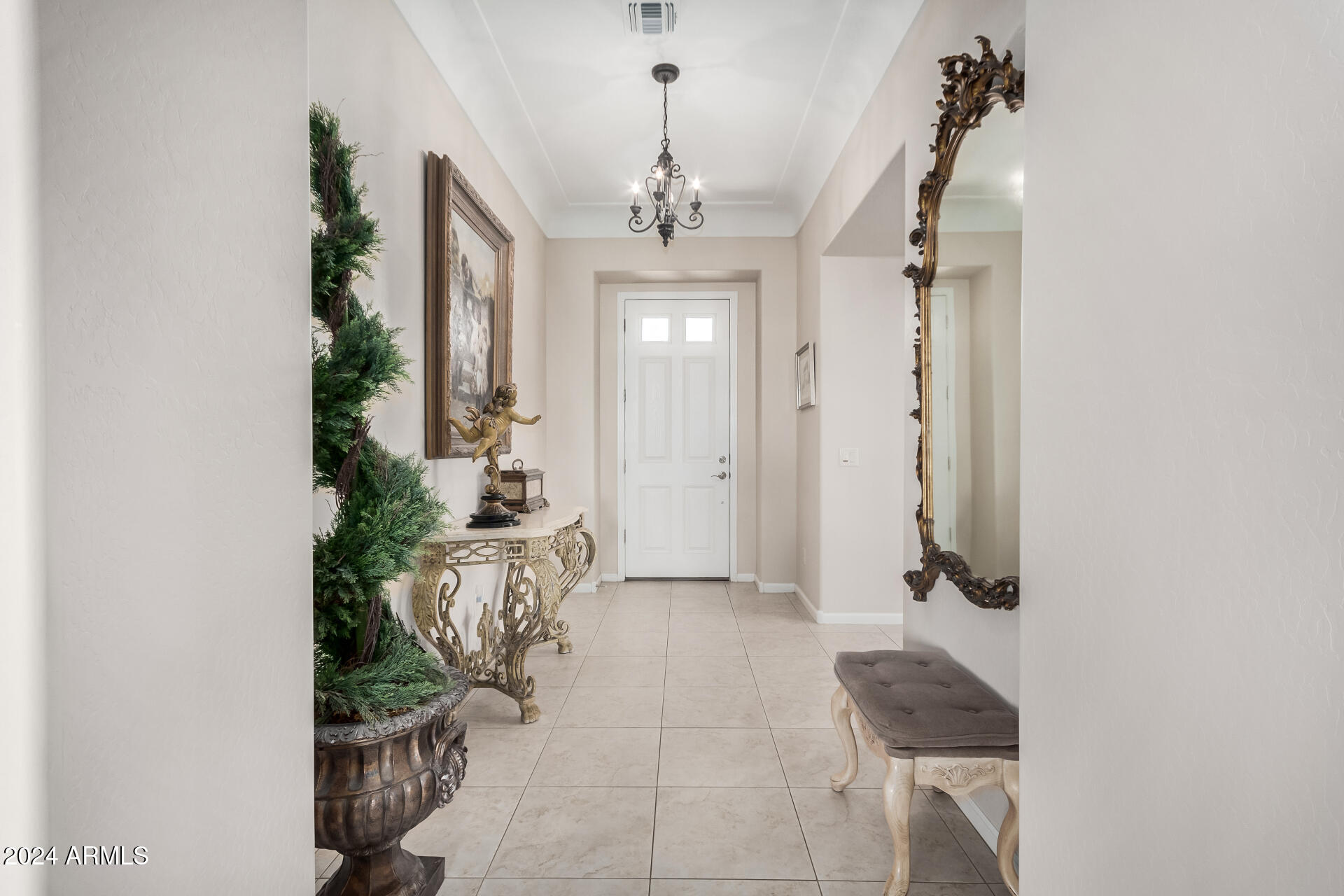 16538 West Berkeley Road Goodyear, AZ 85395 - Photo 3 of 31 a view of a hallway with chandelier and entryway