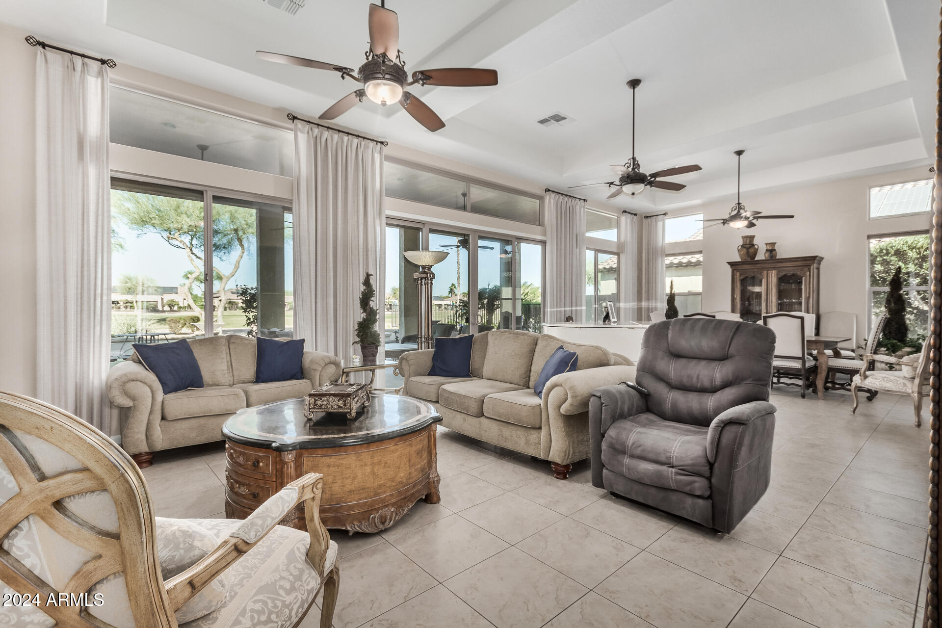 16538 West Berkeley Road Goodyear, AZ 85395 - Photo 5 of 31 a living room with furniture ceiling fan and a large window