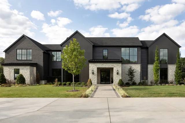 a front view of a house with a yard and garage