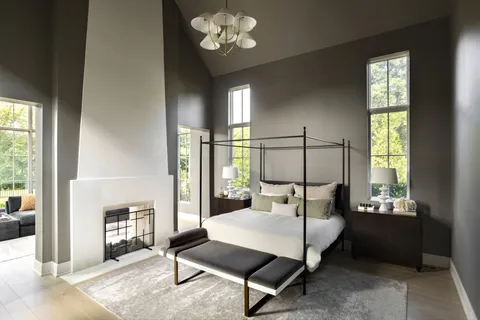 a bedroom with a bed a mirror and a window