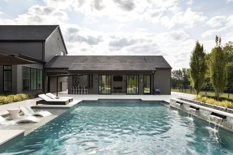 a front view of house with yard and green space