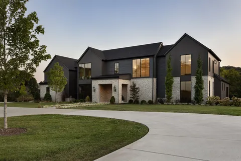 a front view of house with yard and green space