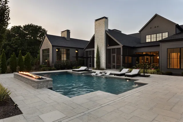 a view of a house with swimming pool and sitting area