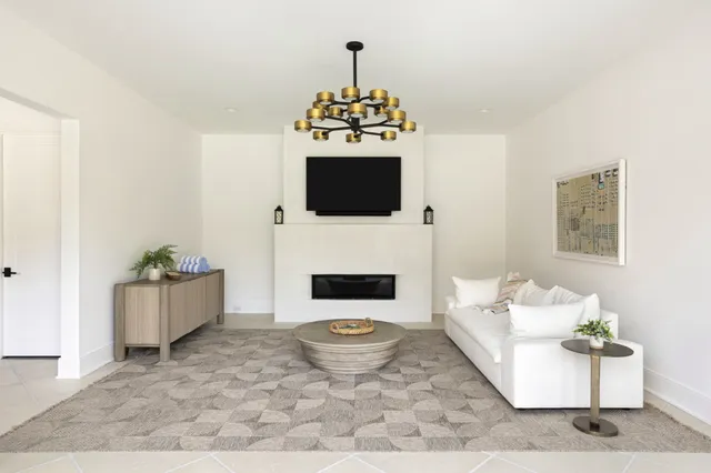 a living room with a couch fireplace and a flat screen tv